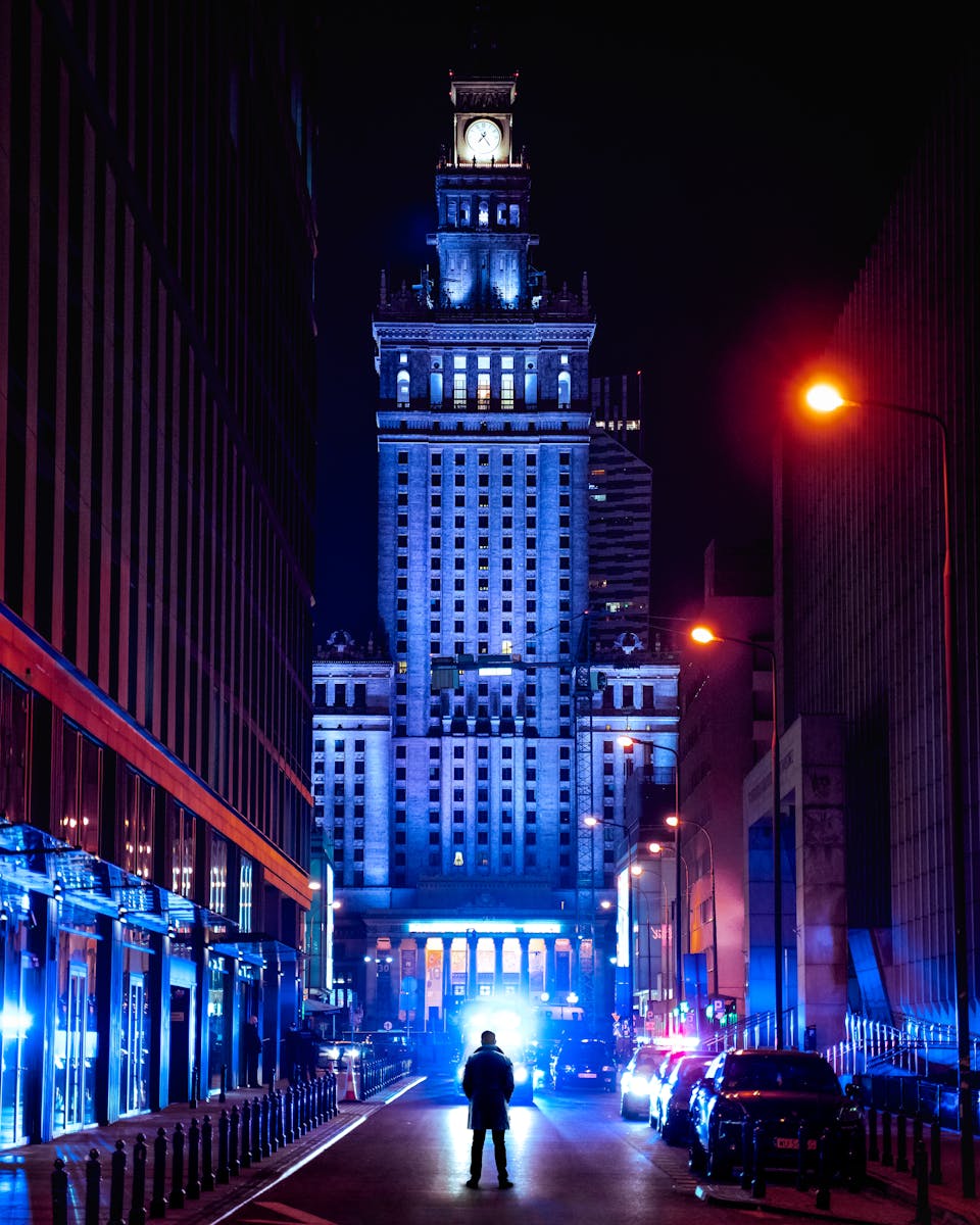 Man in Front of the Palace of Culture and Science in Warsaw at Night